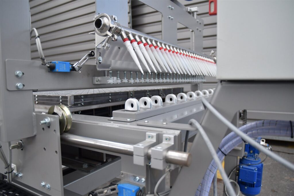 Zbliżenie wtryskiwaczy maszyny tworzącej podesty z FRP.